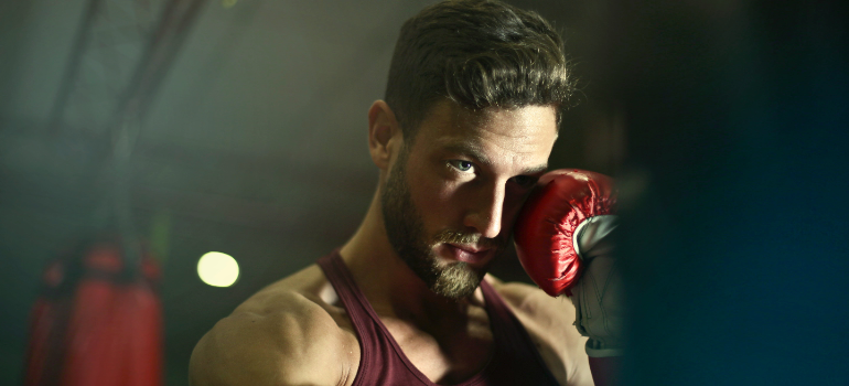 boxing personal trainer uae punching the boxing bag.