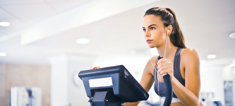 A woman on an elliptical machine at the gym