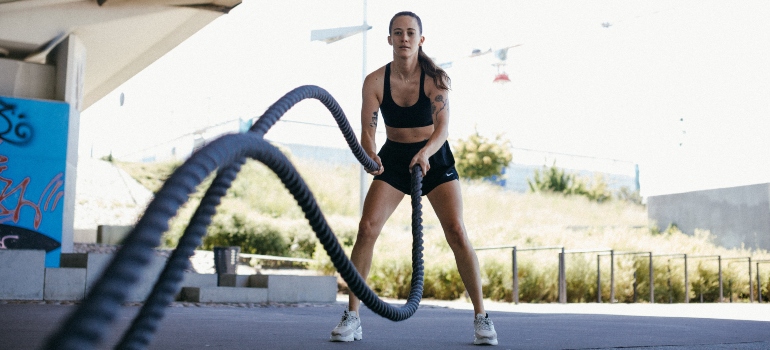 A woman working out with a post injury fitness trainer UAE