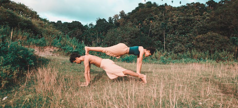A boy and a girl doing yoga poses together.