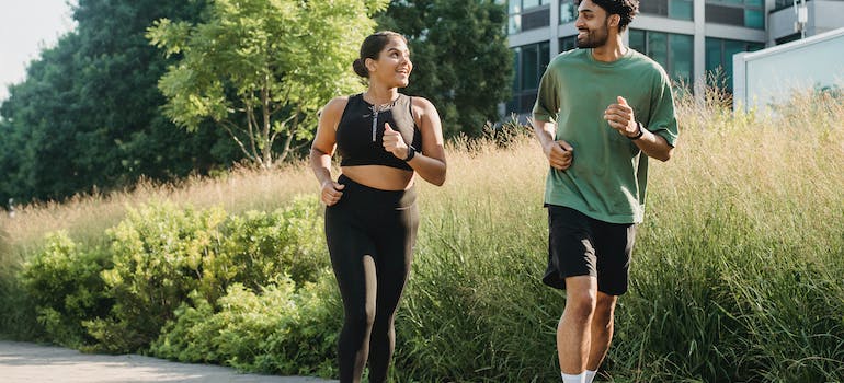 A female personal trainer umm al quwain running outside with a client