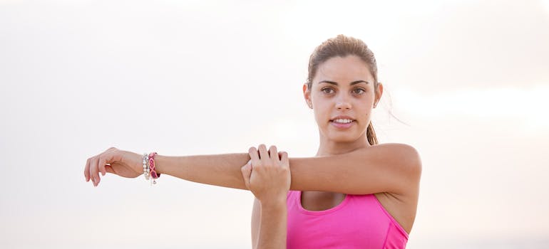 A female personal trainer fujairah stretching her arm