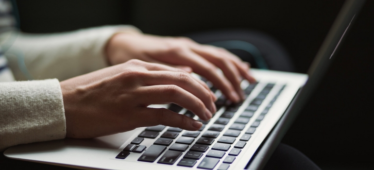 A person using laptop to find a safe workout in Dubai.