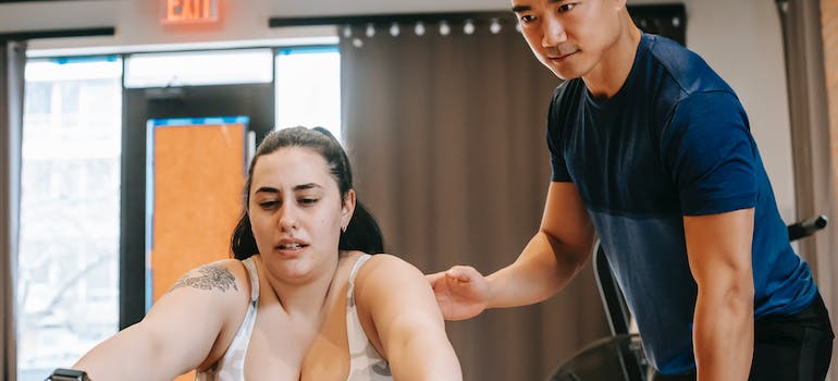 Fitness coach training his client