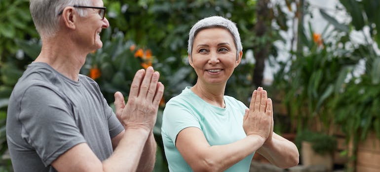 A couple doing yoga outdoors