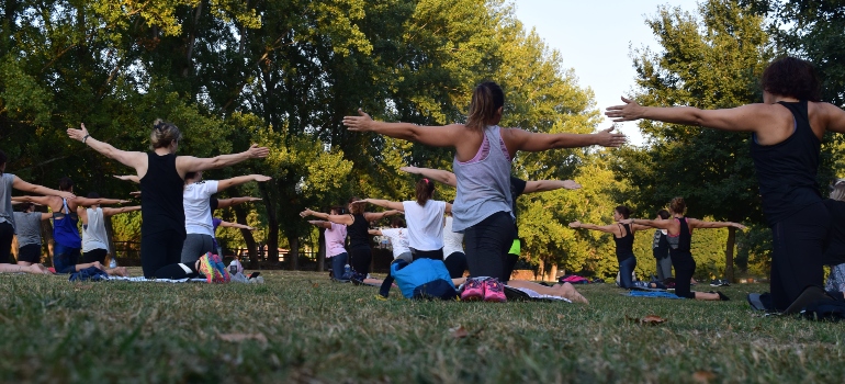 People in the park practicing yoga.