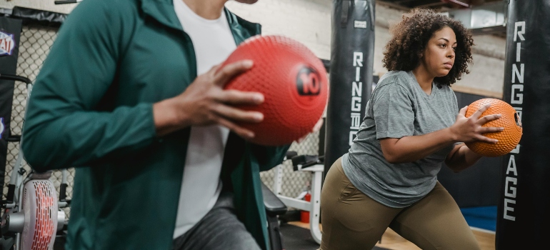A personal trainer working out with his client.