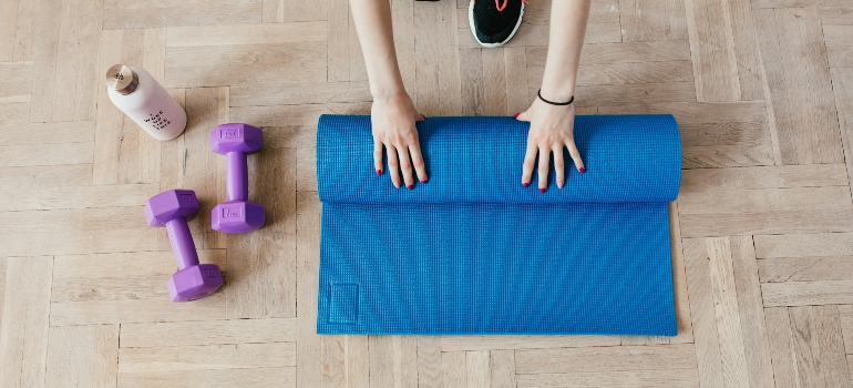 A yoga met and weights on the floor.