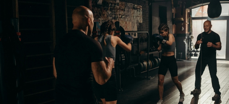 A personal trainer with a boxer, working out.