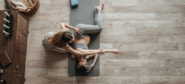 A pregnant woman working out with her personal trainer.