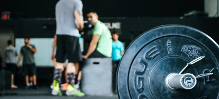 a dumbell on the floor at the gym and people behid