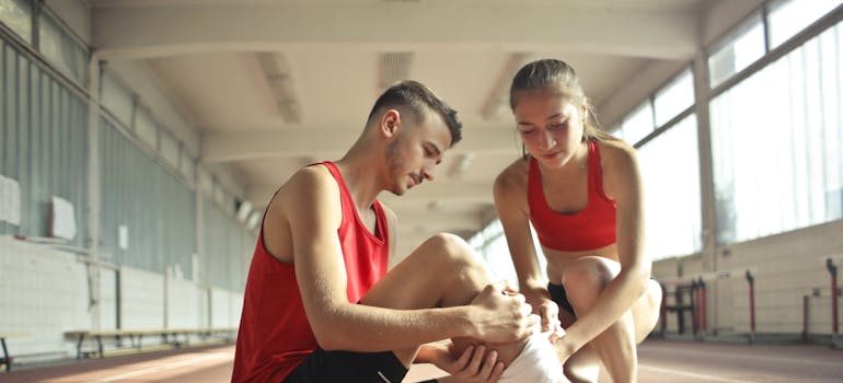 an injured man and a woman helping him