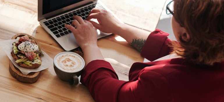 a woman on her laptop planning out her meals