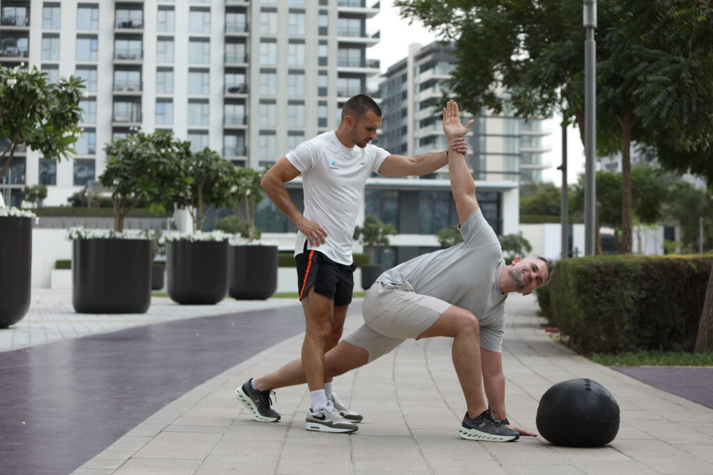 Personal trainer helping a client after injury