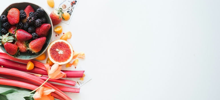 Fruits and flowers on a white surface