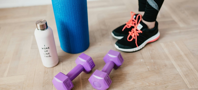 girl standing next to training equipment