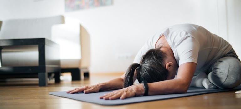 a girl doing yoga on her yoga mat