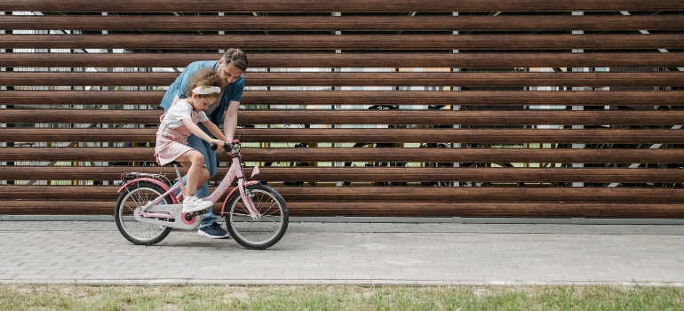 Girl Learning How to Ride a Bicycle is just one of the best weekend fitness habits for families in Ajman