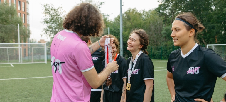 Athlete receiving a medal after a football match, reflecting the confidence and discipline gained from team sports and training.