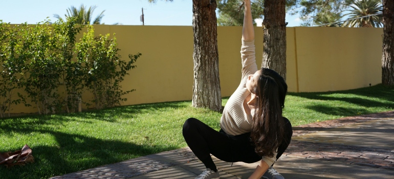 Person squatting showing functional fitness ideas for parents with young kids in the UAE