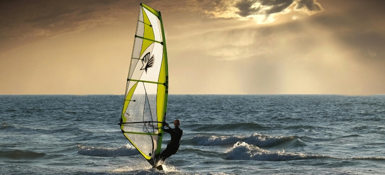 A man is practising windsurfing in Dubai.