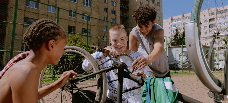 Teenagers repairing a bicycle together, building friendships