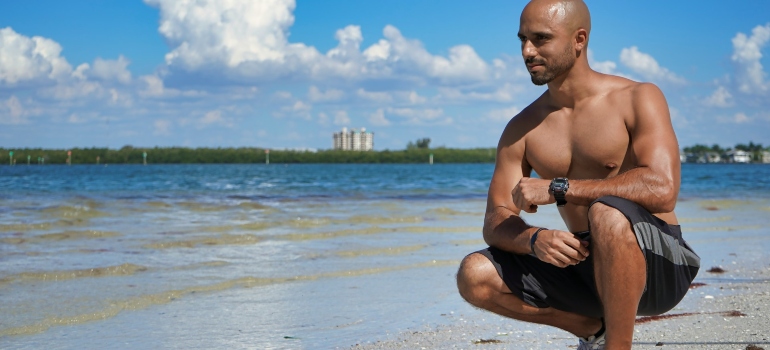Person squatting on a beach