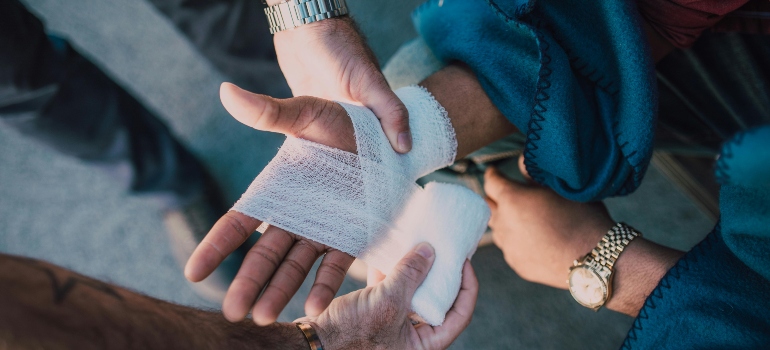 a boy applying a bandage on the hand