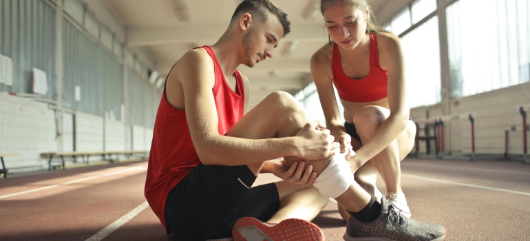 a girl helping an injured boy