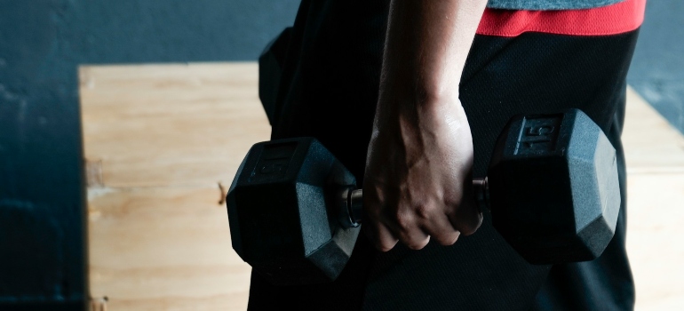 Person holding dumbbells