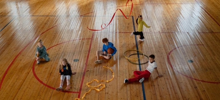 Kids playing on a court during fun sports activities for kids.