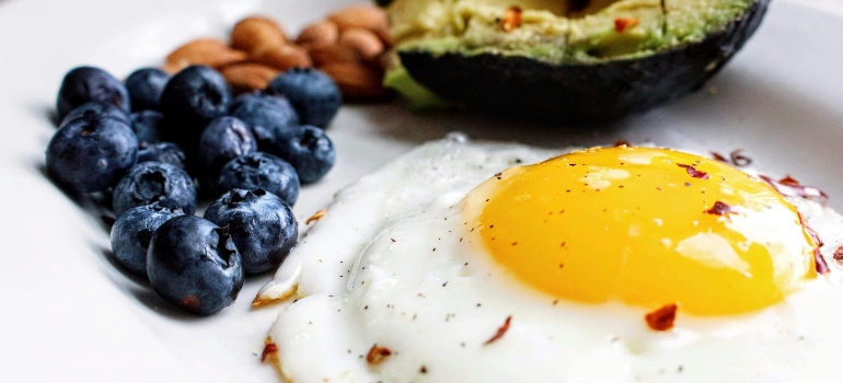 Eggs with blueberries and avocado.