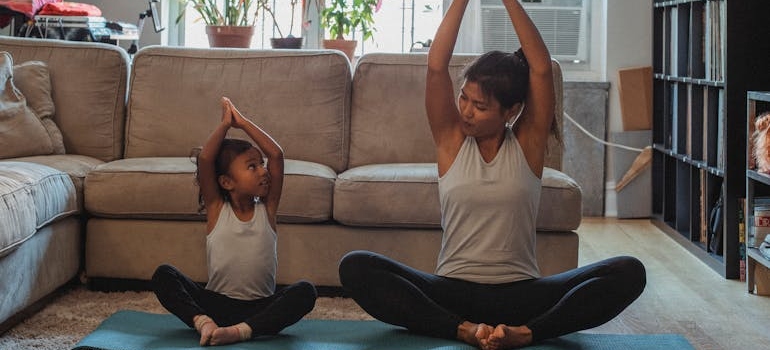 a mother and a child practicing yoga