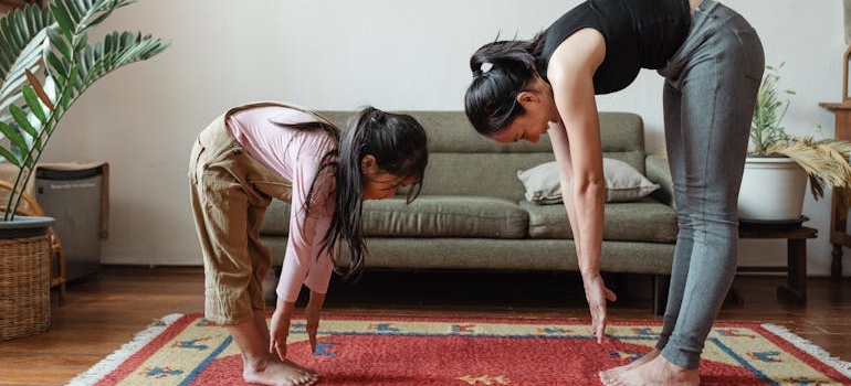 a mother teaching her daughter kids yoga