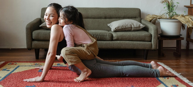 Mother and daughter doing yoga at home