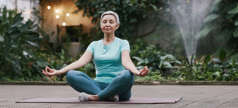 Woman doing youga, part of strength and balance training for seniors in Dubai