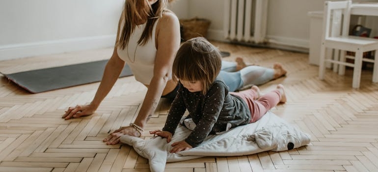 a parent and a child doing yoga