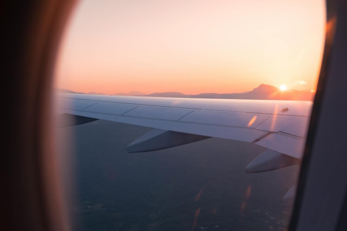 View from an airplane window while thinking about keep your fitness routine consistent while traveling in the UAE